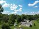 Aerial view of a residential property with mature trees and blue skies at 5387 E County Road 800 S, Mooresville, IN 46158