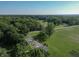 An aerial view of a rural property with lush landscaping, a home, and farmland at 5387 E County Road 800 S, Mooresville, IN 46158