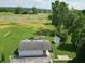 Aerial view of a home with a spacious backyard, two car garage, and surrounding greenery at 5387 E County Road 800 S, Mooresville, IN 46158