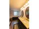 Charming bathroom featuring dual sinks, decorative wallpaper, and wainscoting at 5387 E County Road 800 S, Mooresville, IN 46158
