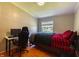 Bright bedroom with a window and hard wood floors that includes a desk and comfortable chair near a full sized bed at 5387 E County Road 800 S, Mooresville, IN 46158