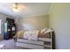 Bright bedroom with white bed frame offering built in drawer storage along with a ceiling fan and neutral colored walls at 5387 E County Road 800 S, Mooresville, IN 46158