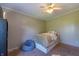 Well-lit bedroom with a ceiling fan, neutral walls, and a cozy beanbag chair, complemented by soft carpeting at 5387 E County Road 800 S, Mooresville, IN 46158