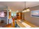 Inviting kitchen showcasing wood cabinets, tiled backsplash, and a view into the dining area at 5387 E County Road 800 S, Mooresville, IN 46158