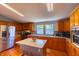 Well-lit kitchen featuring stainless steel appliances, an island, and wooden cabinetry, offering ample storage and counter space at 5387 E County Road 800 S, Mooresville, IN 46158