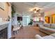 Bright and airy living room with an open layout, ceiling fan, modern decor, and seamless flow to other living spaces at 5387 E County Road 800 S, Mooresville, IN 46158