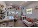 Bright office or craft room with ample desk space, shelving, windows, and a cozy sofa for relaxation at 5387 E County Road 800 S, Mooresville, IN 46158