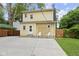 Backyard exterior with large concrete pad and two white chairs and a gate to the side yard at 5715 Oak Ave, Indianapolis, IN 46219