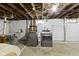 Basement laundry room with open ceiling with plumbing and electrical and newer washer and dryer at 5715 Oak Ave, Indianapolis, IN 46219
