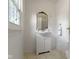 Bathroom with a white vanity, gold mirror, and white tile floor at 5715 Oak Ave, Indianapolis, IN 46219