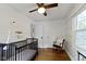 Bedroom with hardwood floors, a rocking chair, a window, and shiplap accent wall at 5715 Oak Ave, Indianapolis, IN 46219