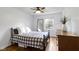 Bright bedroom with hardwood floors features a ceiling fan and a window with a view of the yard at 5715 Oak Ave, Indianapolis, IN 46219