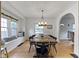 Inviting dining room features hardwood floors, a window seat and an elegant chandelier at 5715 Oak Ave, Indianapolis, IN 46219