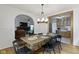 Dining area with an open concept to other rooms featuring a wood table and black chairs at 5715 Oak Ave, Indianapolis, IN 46219