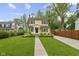 Charming yellow two-story home featuring a well-manicured lawn and inviting front porch at 5715 Oak Ave, Indianapolis, IN 46219