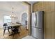 Open kitchen and dining area featuring a large refrigerator and table with six chairs at 5715 Oak Ave, Indianapolis, IN 46219