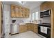 Bright kitchen with light wood cabinets, quartz countertops, and stainless steel appliances at 5715 Oak Ave, Indianapolis, IN 46219