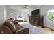 Cozy living room with a brick fireplace, large TV, and comfortable leather seating at 5715 Oak Ave, Indianapolis, IN 46219