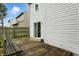 A view of the backyard with a wooden deck and siding on the back of the house at 6495 Titania Dr, Indianapolis, IN 46236