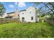 The backyard showcases a grassy lawn, a wooden fence, and the rear exterior of the home at 6495 Titania Dr, Indianapolis, IN 46236