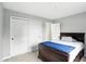 Bedroom featuring storage closets, bed, and access to an additional room at 6495 Titania Dr, Indianapolis, IN 46236