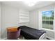 Bedroom with a built-in shelving, metal frame bed, and a large window at 6495 Titania Dr, Indianapolis, IN 46236