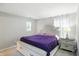 Bright bedroom featuring a storage bench, tufted headboard, and a gray walls at 6495 Titania Dr, Indianapolis, IN 46236