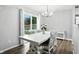 Bright dining room with a modern chandelier and access to the backyard through sliding glass doors at 6495 Titania Dr, Indianapolis, IN 46236