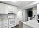 Bright kitchen features white cabinetry, modern appliances, and a speckled countertop at 6495 Titania Dr, Indianapolis, IN 46236
