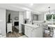 Updated kitchen boasts stainless steel appliances, granite countertops, and an open layout to dining area at 6495 Titania Dr, Indianapolis, IN 46236