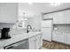 This kitchen features a view to the dining area, white cabinets and granite countertops at 6495 Titania Dr, Indianapolis, IN 46236