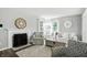 Cozy living room with a fireplace, comfortable seating, and lots of natural light at 6495 Titania Dr, Indianapolis, IN 46236
