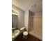 Simple bathroom features a basic vanity, toilet, and walk-in shower at 6611 Wandering Way, Indianapolis, IN 46241