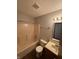 Modest full bathroom features neutral tile surround and updated vanity at 6611 Wandering Way, Indianapolis, IN 46241