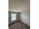 Modest bedroom with neutral walls, carpeting and a window for natural light at 6611 Wandering Way, Indianapolis, IN 46241