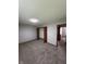Bedroom with carpeting, closet, neutral walls, and doorway to hallway at 6611 Wandering Way, Indianapolis, IN 46241