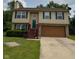 Charming two-story home featuring green shutters, a well-maintained lawn, and an attached two-car garage at 6611 Wandering Way, Indianapolis, IN 46241