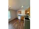 Efficient kitchen with wood cabinets, laminate countertops, and wood-look vinyl flooring at 6611 Wandering Way, Indianapolis, IN 46241
