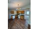 Kitchen featuring wood cabinets, laminate countertops, and open floor plan leading to the living area at 6611 Wandering Way, Indianapolis, IN 46241