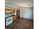 Bright kitchen boasts wood cabinets, modern appliances and eat in area with hardwood style floors at 6611 Wandering Way, Indianapolis, IN 46241