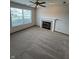 Inviting living room features a cozy fireplace, ceiling fan, and neutral carpet at 6611 Wandering Way, Indianapolis, IN 46241