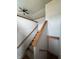 Well-lit staircase with carpeted steps and wooden banister, leading to the upper level of the home at 6611 Wandering Way, Indianapolis, IN 46241