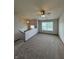 Spacious upper level landing with neutral carpet, a ceiling fan, and ample natural light from the windows at 6611 Wandering Way, Indianapolis, IN 46241