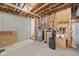 Unfinished basement with exposed pipes, water heater, water softener, and concrete walls, ready for customization at 6733 Jons, Zionsville, IN 46077