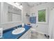 Nautical themed bathroom with a white vanity and blue countertop, with a shower/tub combo at 6733 Jons, Zionsville, IN 46077