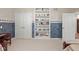 Bedroom with white built-in shelves and closet, nautical wallpaper, and a beige carpet at 6733 Jons, Zionsville, IN 46077