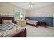 Bedroom with two twin beds, wood furniture, and a window with white shutters at 6733 Jons, Zionsville, IN 46077