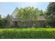 Classic brick home with mature landscaping, arched entry, and manicured hedge, offering a timeless curb appeal at 6733 Jons, Zionsville, IN 46077