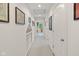 Hallway with neutral carpet, framed artwork, white trim and doors, and natural lighting at 6733 Jons, Zionsville, IN 46077