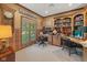 Inviting home office with wood trim, built-in shelves, and a large window at 6733 Jons, Zionsville, IN 46077